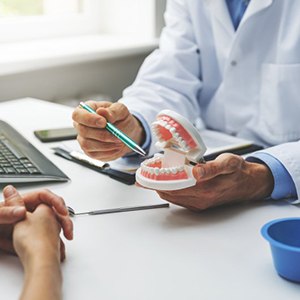 a dentist explaining how dental implants work