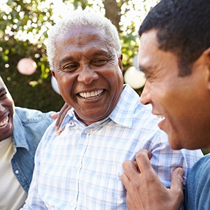 Dentures patient in Garner smiling with family
