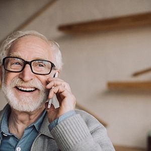 Patient in Garner talking on phone with dentures