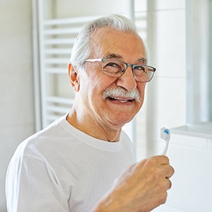 Dentures patient in Garner brushing teeth