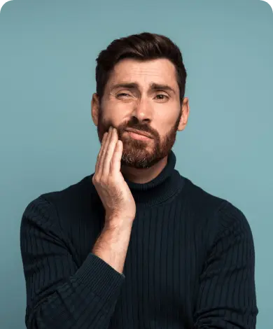 man holding jaw in pain