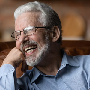 Man smiling in a luxurious leather chair