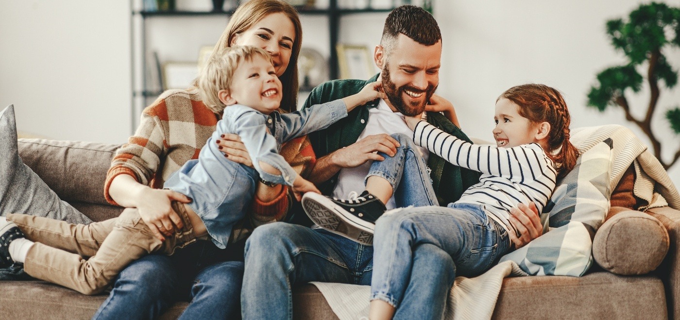 Family of four playing on couch