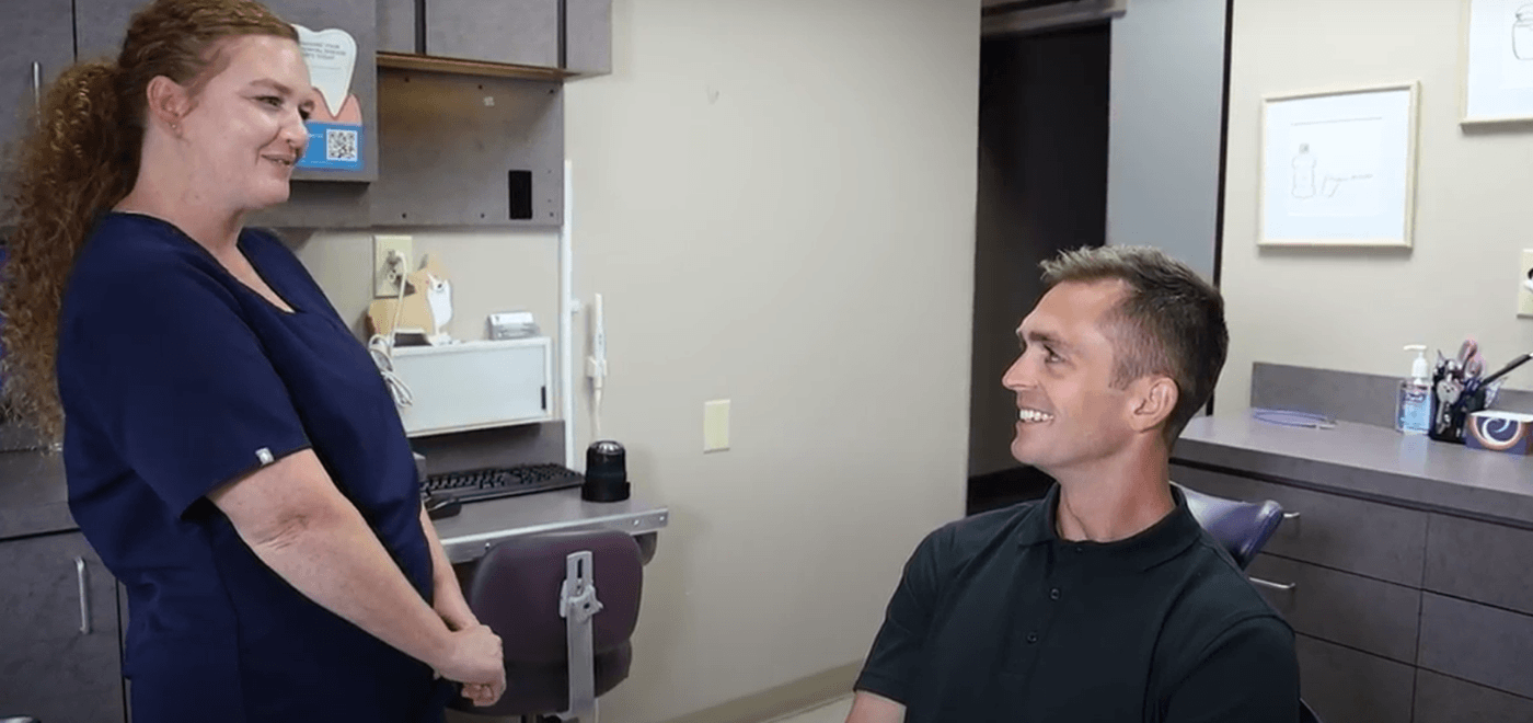 Man smiling while seeing his dentist for orthodontics in Garner
