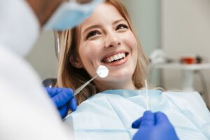 Woman with blond hair in dental chair about to undergo exam